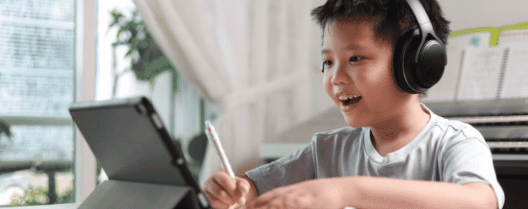 Child using a 2-in-1 tablet to study