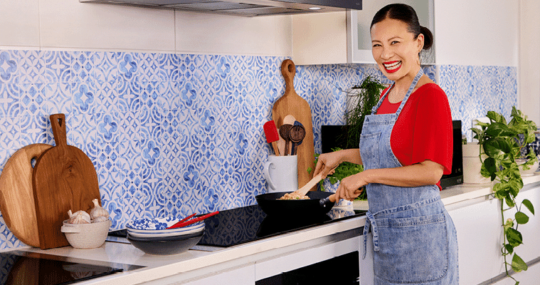 Image of Poh Ling Yeow happily cooking on an LG induction cooktop